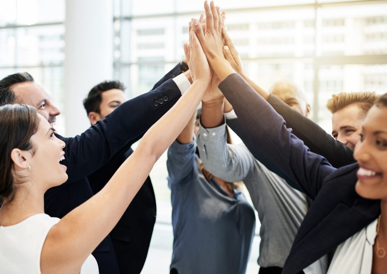 A group of co-workers celebrating their successful Motivational Intelligence based Sales Leadership training course completion