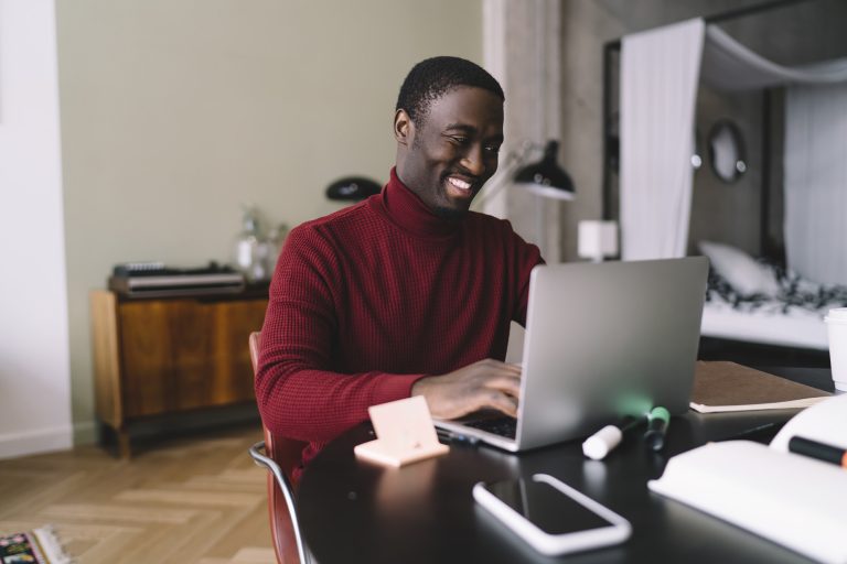 A happy student studying a Self-Leadership Development Training course online