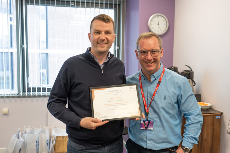 A Growth Leadership Graduate Celebrating Completion with Trainer and coach Alan